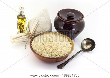 The Composition Of Steamed Rice Groats In A Clay Pial Next To A Clay Pot And A Copper Spoon,
