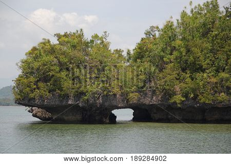 Opening underneath the islands 
An artistic cut underneath two rocky islands in Cantilan, Surigao del Sur, Philippines