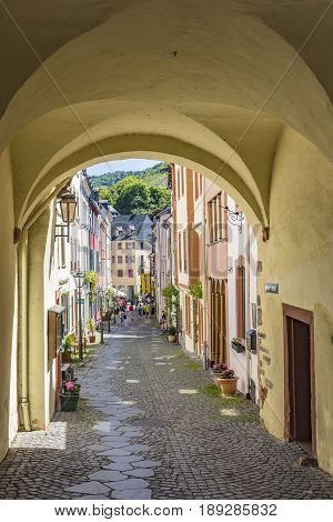 People Enjoy The River Cruise On River Moselle With View To Old Historic Town Of Bernkastel-kues