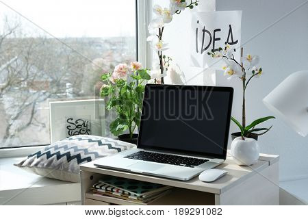 Creative workplace near windowsill in modern room