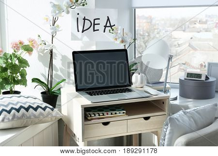 Creative workplace near windowsill in modern room