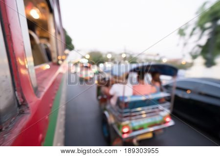 Blur Tuk Tuk in Bangkok take pictures from the buses in traffic jam. Auto rickshaw.