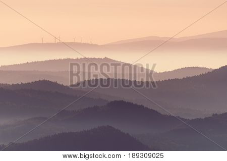Morning foggy landscape and wind turbines on an aerial shot.