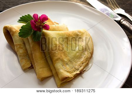 Stack of thin crepes (blini) with honey for breakfast. overhead view. russian food