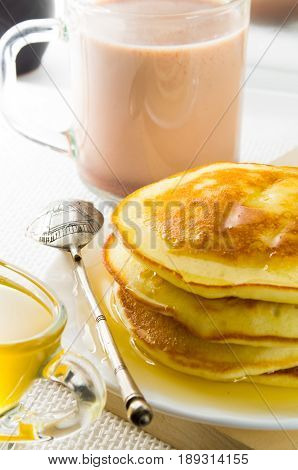 Glass Mug With Cocoa, Silver Spoon, Honey And Pancakes