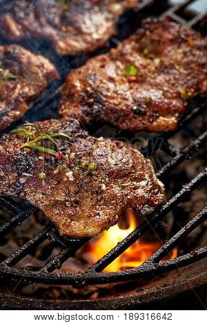 Grilled pork neck fillet steaks on grill plate