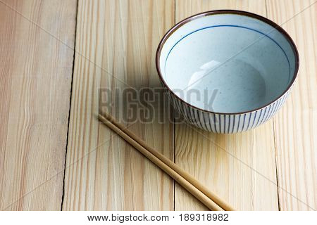 japanese Bowl and chopsticks on the wooden table