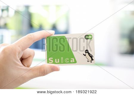 Tokyo Japan - April 23 2017 : Man hold Suica pass with the blurred background Suica is a prepaid card for travelling with train bus and shopping in Japan.