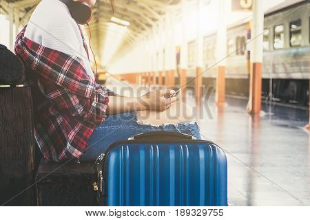 Alone Travler With Headphone And Suitcase And Cell Phone At Railway Platform In Summer, Alone Travel