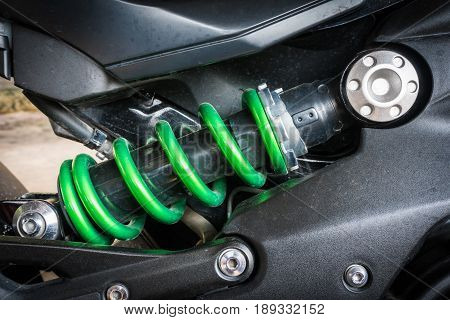 Modern motorcycle shock absorber a device for absorbing jolts and vibrations especially on a motor vehicle with stain from raindrop. Select focus