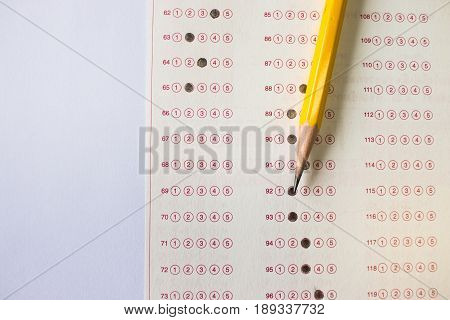 yellow pencil on exam answer sheet education test concept