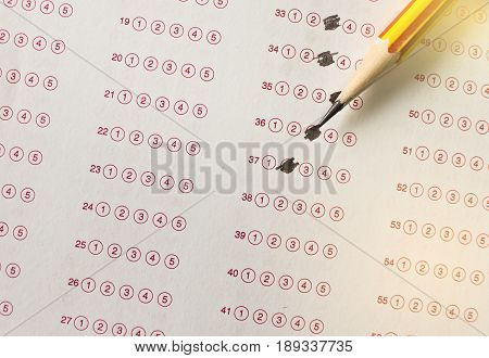 yellow pencil on exam answer sheet education test concept