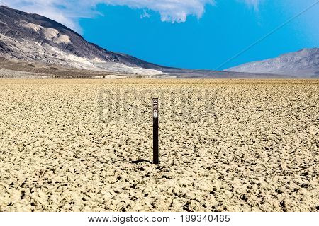 view over the dried salt see of Searles Lake to the panamid mountains it is forbidden to enter the area