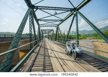 PAI THAILAND - 24 MAY 2017: Old motorcycle on the Memorial Bridge in Pai district at Mae Hong Son province, Thailand.
