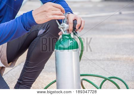 man use oxygen cylinder equipment for helpcare treatment