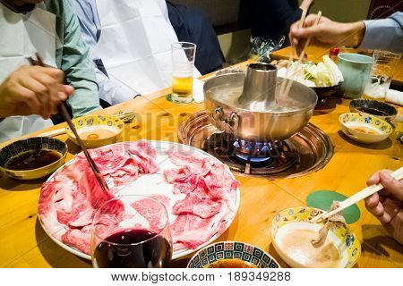 People Dining With Raw Japanese Kobe Beef Shabu-shabu Steamboat