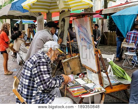 PARIS, FRANCE-JULY, 2016: Montmartre Street Painters, colorful and famous Place du Tertre