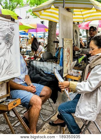 PARIS, FRANCE-JULY, 2016: Montmartre Street Painters, colorful and famous Place du Tertre