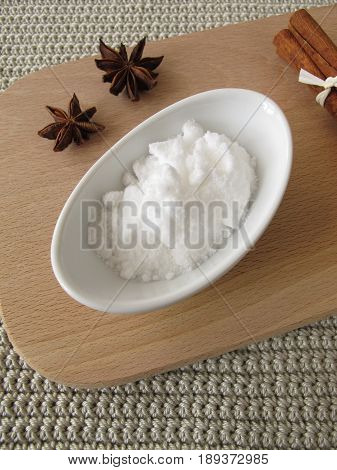 Bakers ammonia in bowl and spices on wooden board