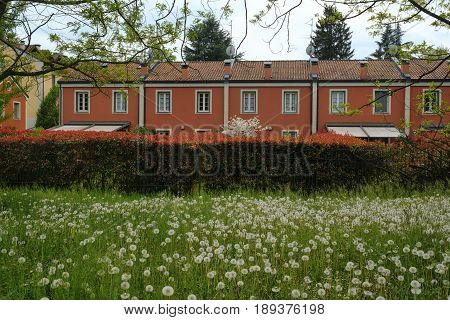 Red facade of building along the bicycle path of the Lambro valley (Monza Brianza Lombardy Italy) at spring