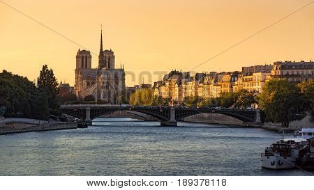 Notre Dame de Paris Cathedral Ile Saint Louis the Sully Bridge and the Seine River at sunset in Summer. 4th Arrondissement of Paris. France