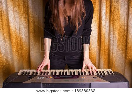 Unrecognizible Girl Musician Playing On Electronic Piano