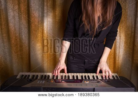 Unrecognizible Girl Musician Playing On Electronic Piano