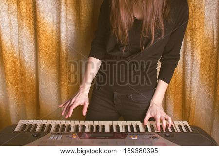 Unrecognizible Girl Musician Playing On Electronic Piano