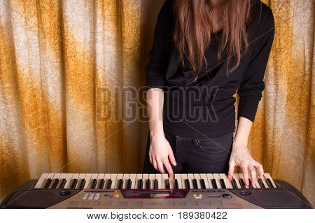 Unrecognizible Girl Musician Playing On Electronic Piano