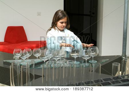 Child Making Music With Glasses