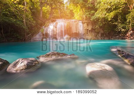 Blue stram waterfall in tropical deep forest natural landscape background