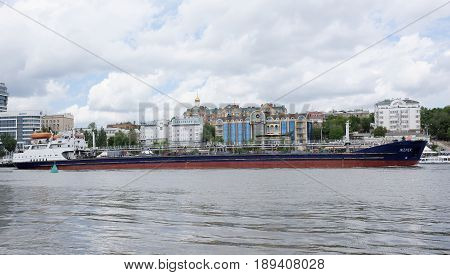 Rostov-on-Don Russia - May 282017: On the Don River sailing freighter. On the waterfront walk people
