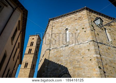 Volterra, Tuscany - May 21, 2017 - Baptistery Of San Giovanni Battista And Tower Of Cathedral