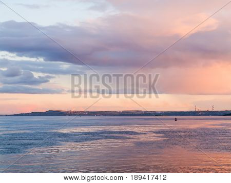 Scenic evening river landscape. Blue and pink sky at sunset. Russia, Saratov city, the Volga river