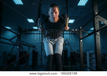Athlete on training, exercise on gimnastic rings