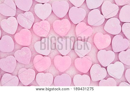 Old fashion pale pink colored candy heart background