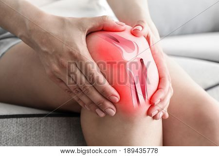 Health care concept. Woman suffering from pain in knee, closeup