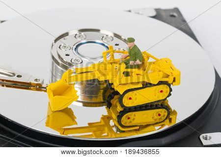 HDD with toy crawler mounted - data security concept.