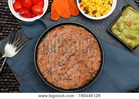 Black bean dip with peppadew, corn, guacamole and dried mango.