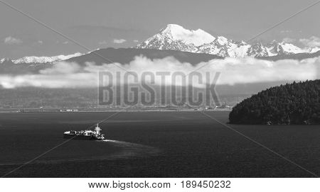 a large ship sets out in Puget Sound with Mt Baker overlooking