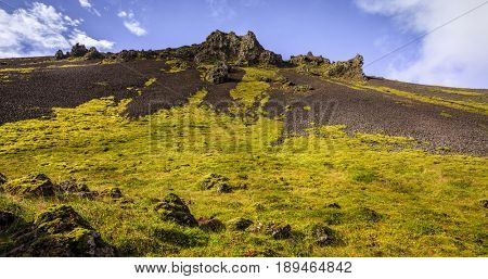 Volcanic rock formations in Reykjadalur Valley in South Iceland