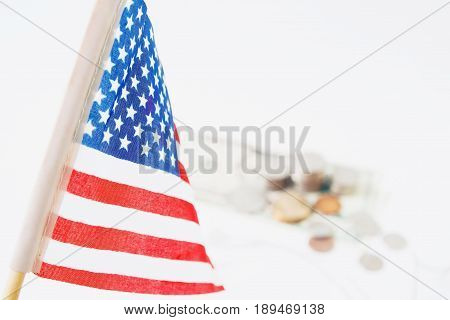 USA flag stack of coins and dollors in background selective focus. Travel America concept