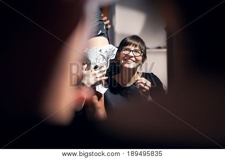 A professional tattooist is presented with sketch on the body of the girl in the Studio. Girl master and model