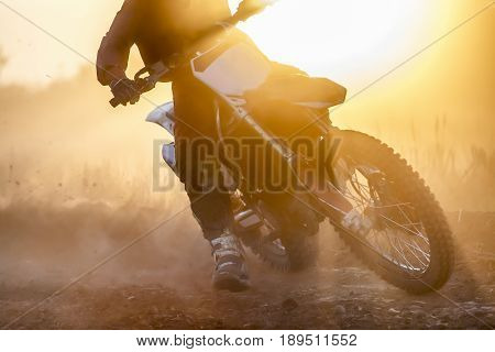 Silhouette motocross race speed in dirt track.