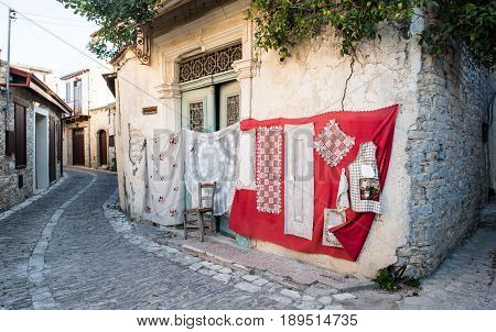 Lefkara Cyprus - August 21 2016: Handmade lace called lefkaritika hanging on the wall of a house at Lefkara village Larnaca district Cyprus