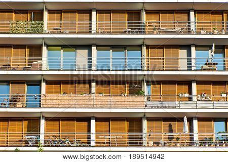 Facade with balconies of a modern orange apartment building