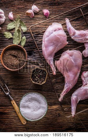 Rabbit. Raw rabbit slices with spices garlic kitchen utensilfork and butcher. Hunting cuisine.