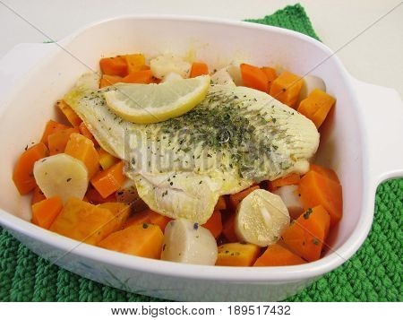Steamed plaice on vegetables in cooking pot