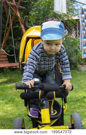 boy holding a small steering wheel bicycle