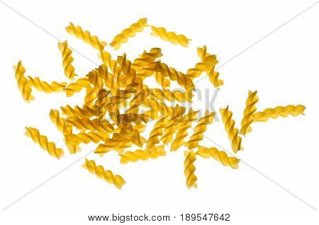 Dried raw uncooked spirelli pasta noodles backlit isolated on white background